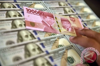 Petugas jasa penukaran valuta asing memeriksa lembaran mata uang rupiah dan dollar AS di Jakarta 