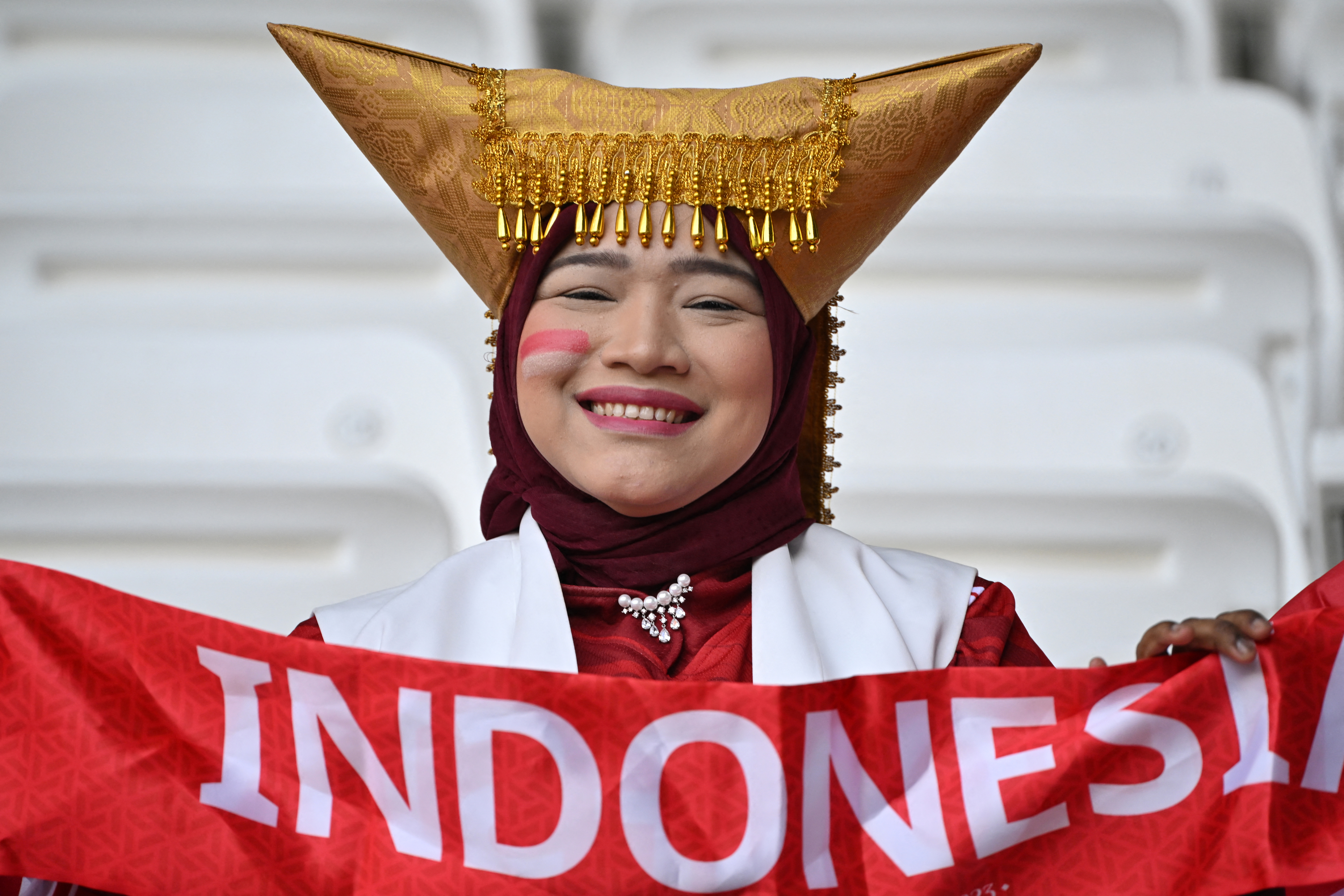 An Indonesia supporter poses before the start of the Qatar 2023 AFC Asian Cup football match between Australia and Indonesia at the Jassim bin Hamad Stadium in Doha on January 28, 2024. (Photo by HECTOR RETAMAL / AFP)